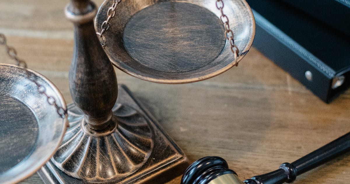 Scales of justice and wooden gavel on desk — are prediction markets legal regulation