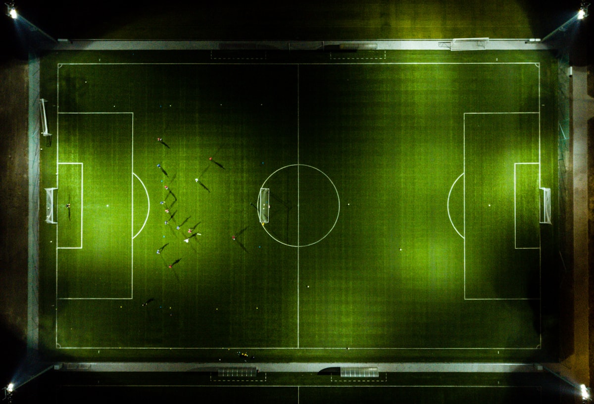 Aerial football pitch green field with tactical markings — how to predict World Cup matches
